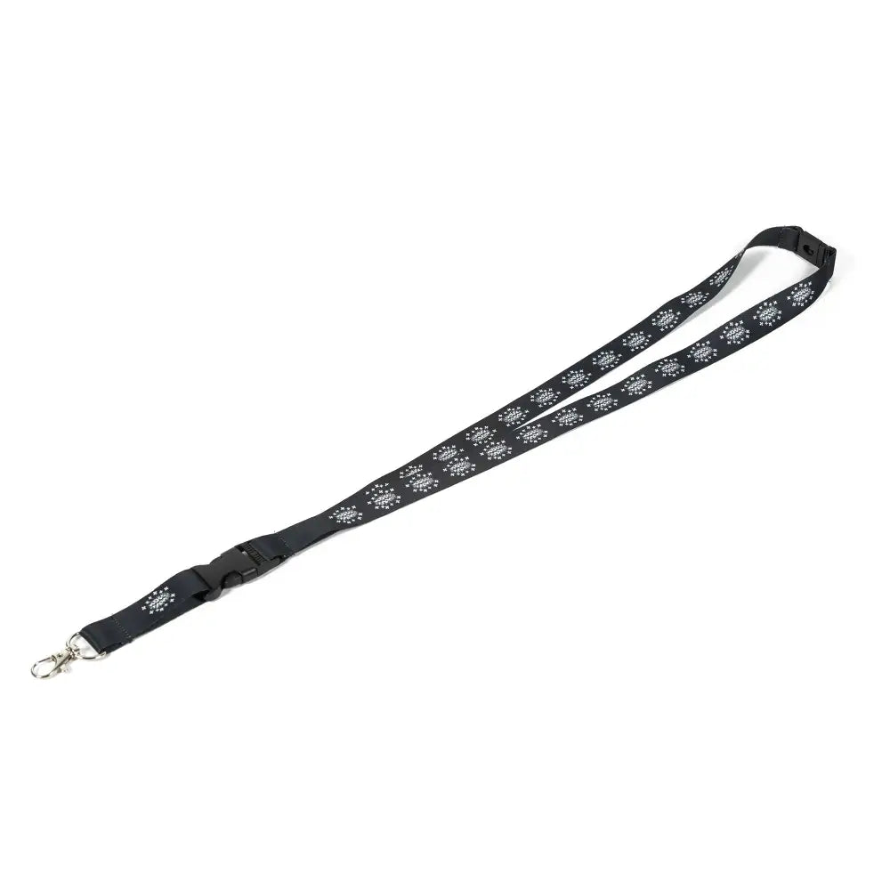 Avainnauha tuhero musta kangasnauha valkoisilla tassukuvioilla ja säädettävällä muovilukolla