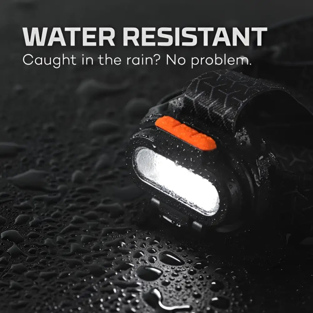 Black waterproof einstein 1500 flex headlamp with orange power button and bright white led light