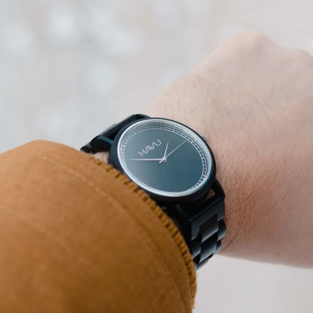 Black wooden havu watch with a sleek minimalist design and dark gray dial puinen rannekello virta 42mm