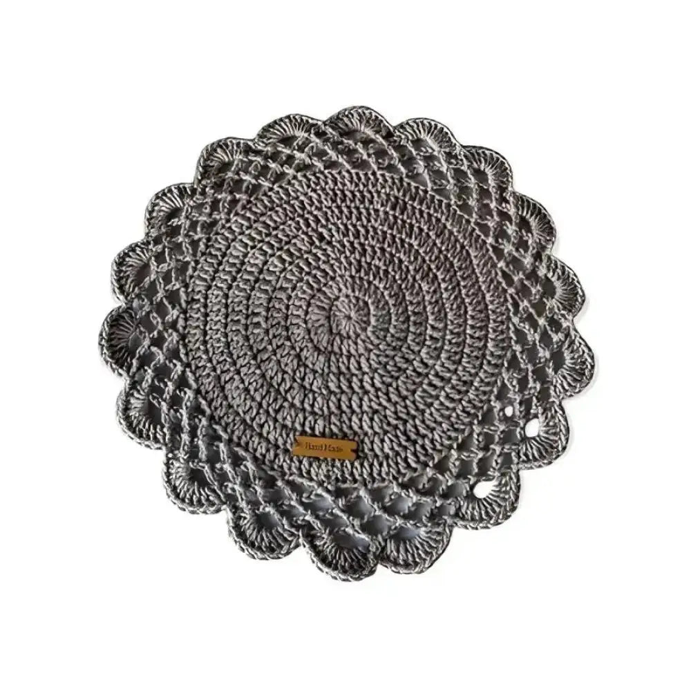 Gray crocheted kattausliina crochet placemat with scalloped edge and concentric circular pattern