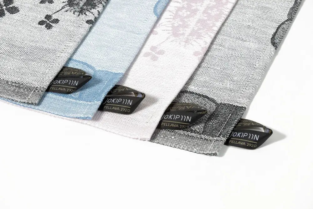 Four linen keittiöpyyhe with floral patterns in light blue white and gray tones by jokipiin pellava