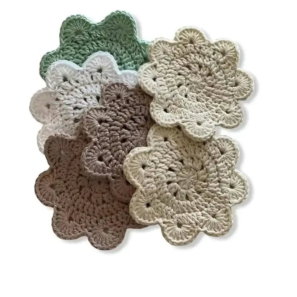 Hand-crocheted lasinalunen pipari floral coasters in soft sage green cream and beige tones