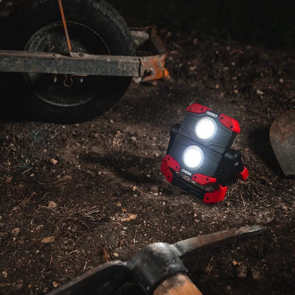 Red and black Nebo Omni 2k worklight with two bright circular bulbs for portable and durable lighting use