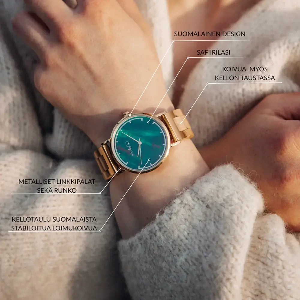 A sleek gold-toned wooden watch revontuli koivu with a vibrant teal safirilasi dial and minimalist silver hands