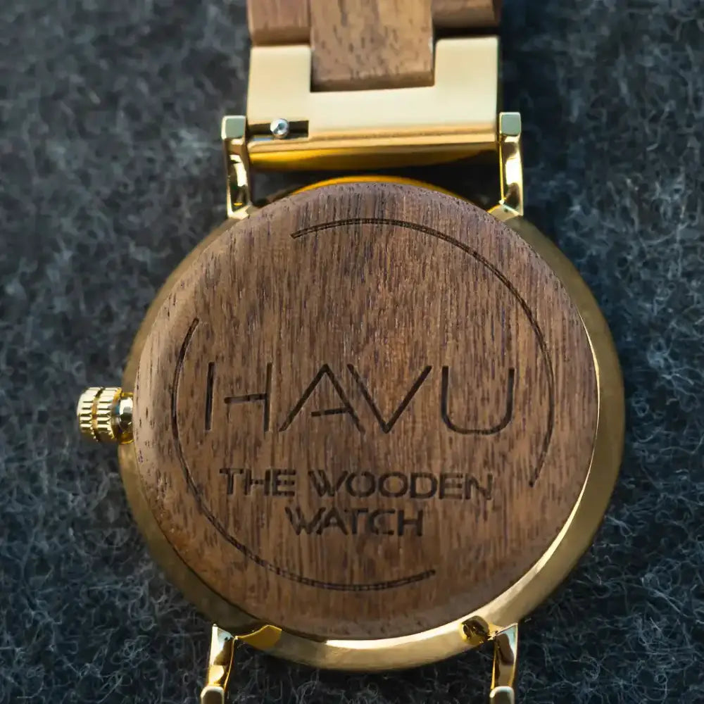 A sleek wooden watch revontuli pähkinäpuu 40mm with gold-tone metal case and engraved havu branding