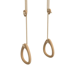 Natural wooden gymnastic rings with a smooth light brown oak finish and beige rope suspension for fitness use