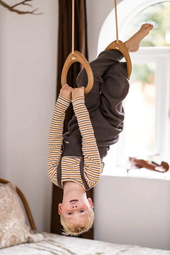 Light brown oak gymnastic rings suspended by ropes designed for fitness training in rings - oak - mint product