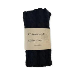 Black textured yarn skein with beige finnish label and knitting needle graphics for sääristimet mix and match