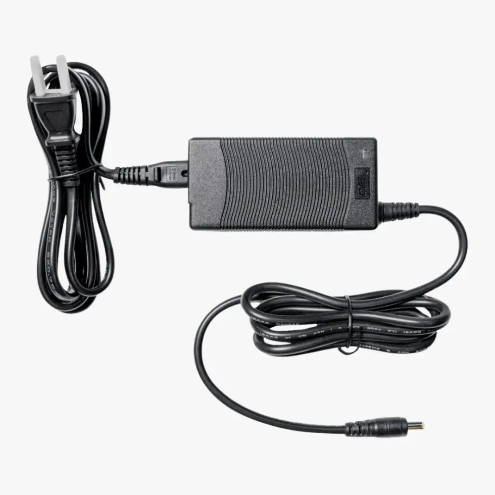 Musta muovinen simagic accessories power supply p-aps virtasovitin ryppyisellä pinnalla ja kierretyillä kaapeleilla