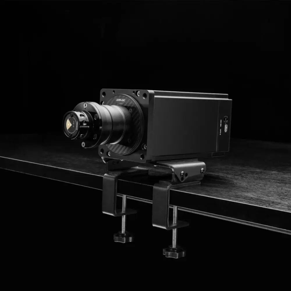 Black industrial-style simagic desk clamp wheelbase with matte finish and carbon fiber accents mounted on clamp