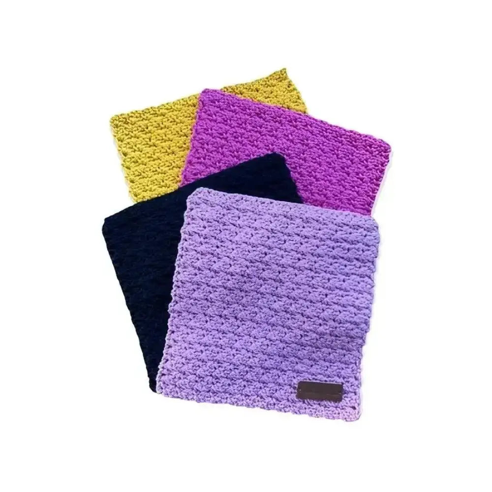 A soft textured lavender crochet coaster tiskirätti sikin sokin with a small brown leather tag