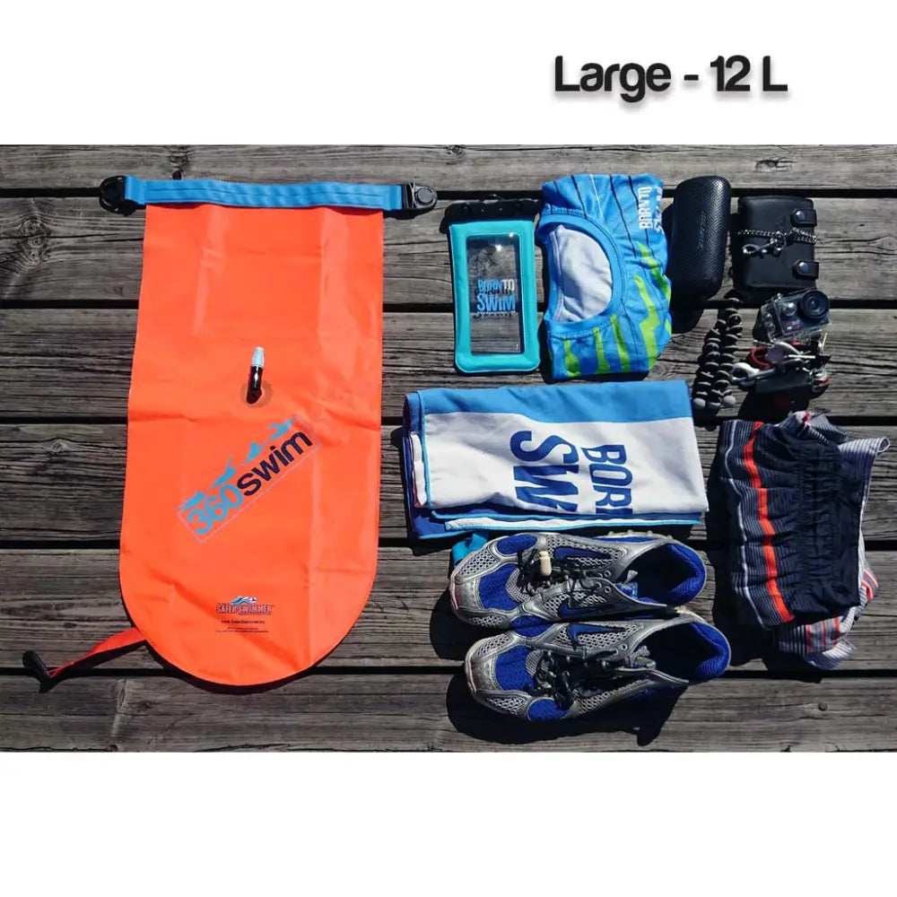 Bright orange ultra drybag buoy inflatable swim bag with blue roll-top closure and 30swim branding